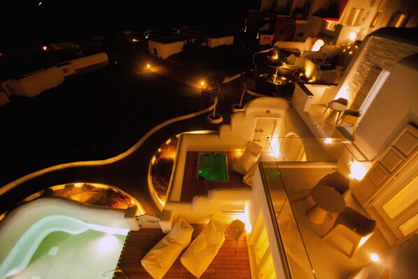 A rooftop terrace with a hot tub, lounge chairs, and a small pool area. - Golden Sun Hotel (Naxos)