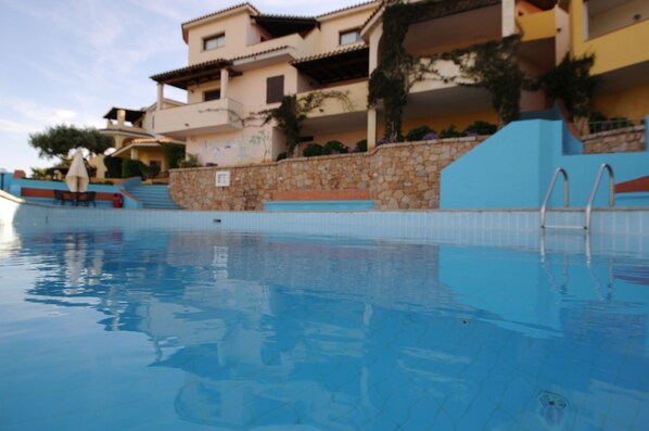 Seasonal outdoor pool, open 10:00 AM to 8:00 PM, pool umbrellas