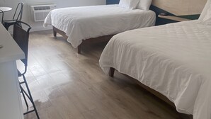 A hotel room with two beds, a desk, and a chair. - Varsity North (Centralia)