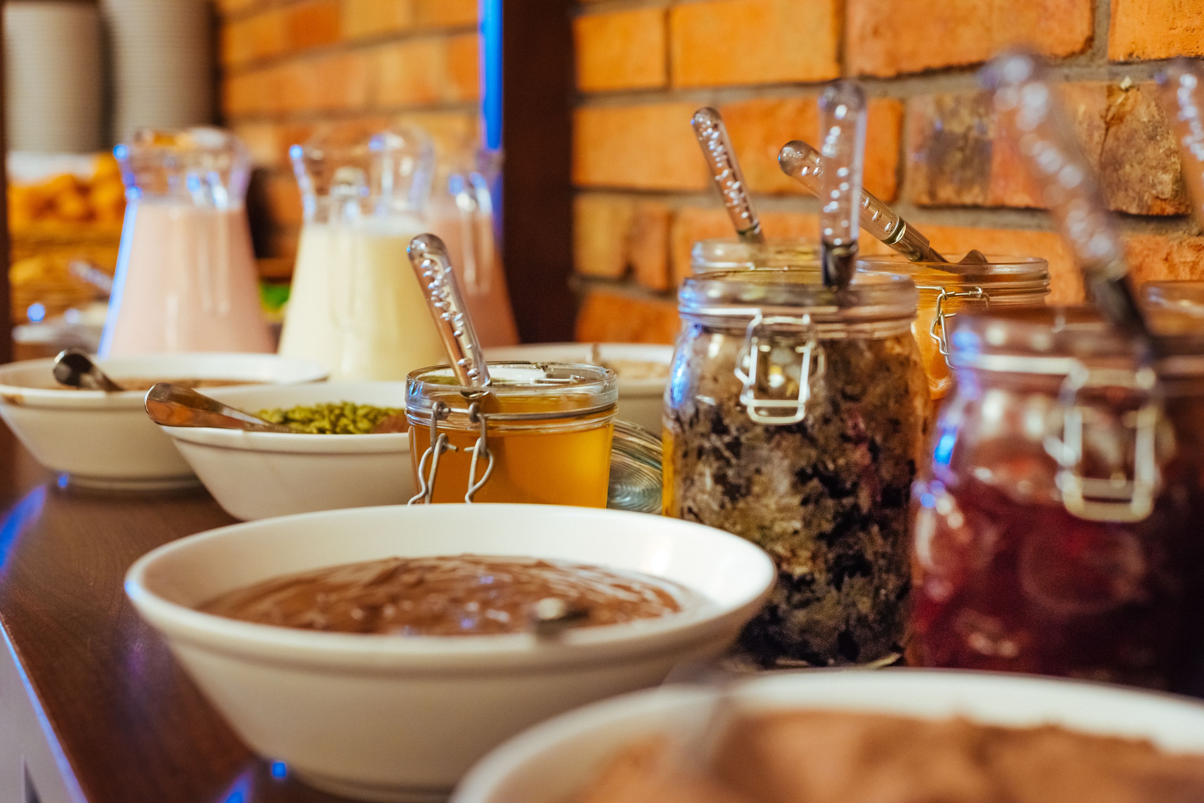 A buffet table with various food items and beverages.