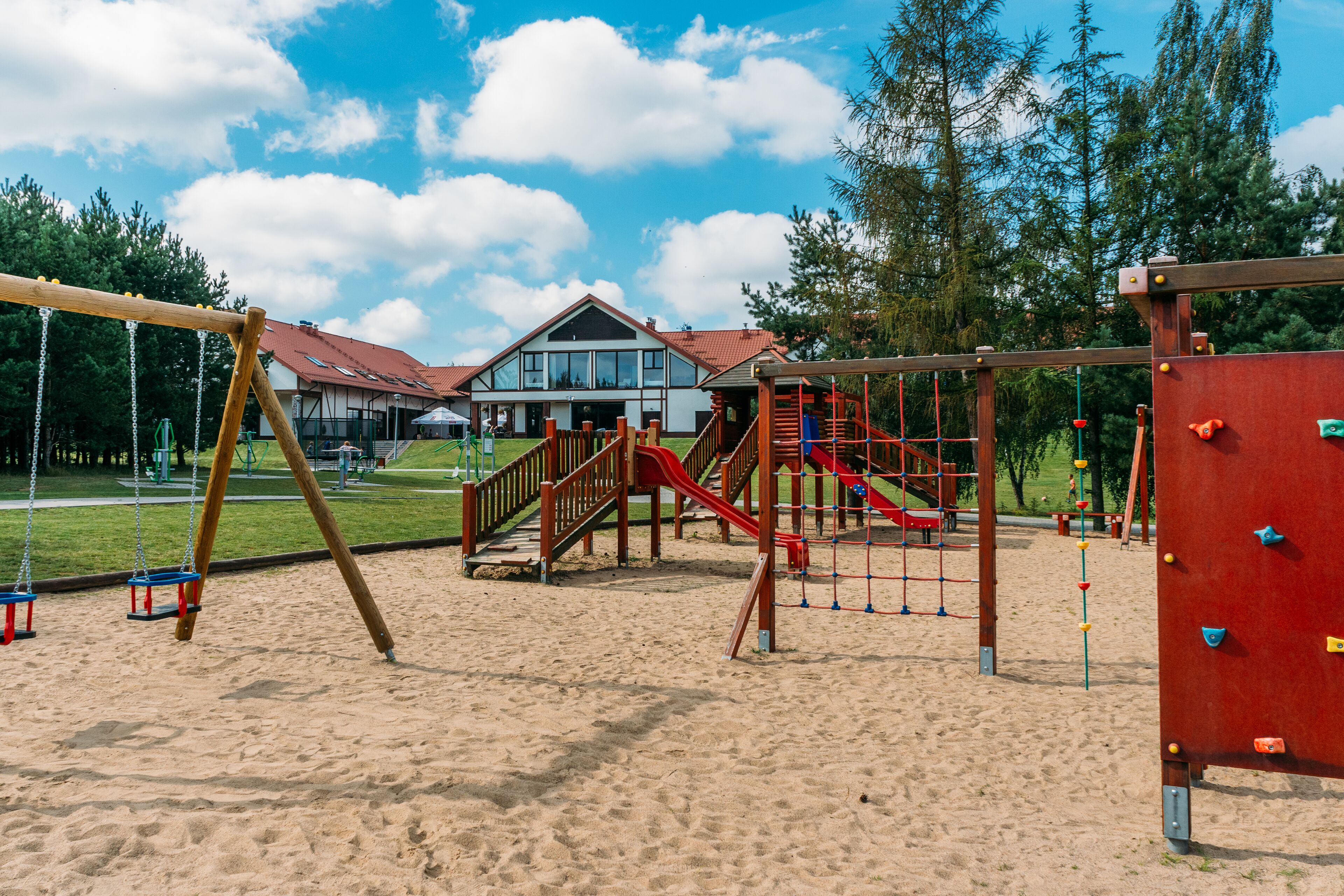 A playground with swings, slides, and climbing structures.