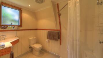 Een badkamer met toilet, wastafel en douche.