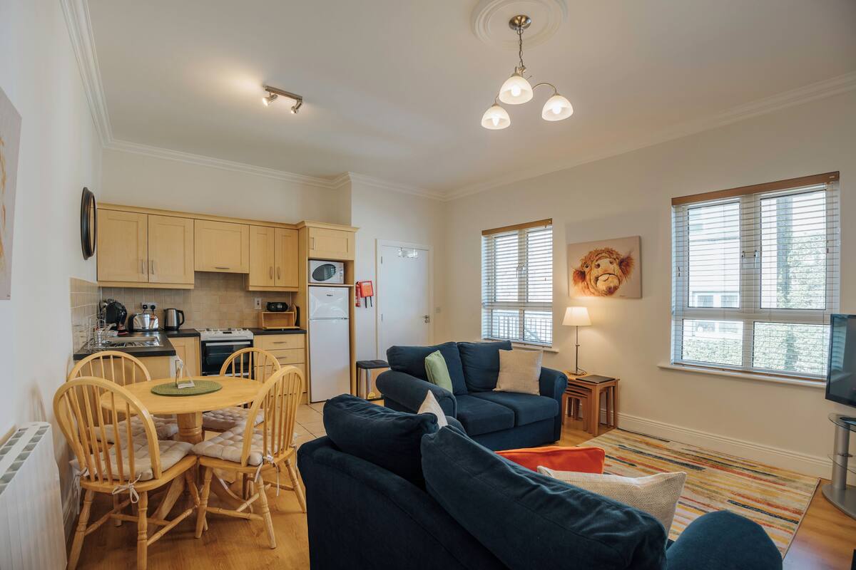A compact living space with a kitchen, dining area, and seating area.