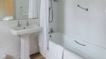 A bathroom with a white sink, a bathtub, and a shower.