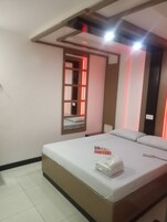 Deluxe Room, 1 Queen Bed | Living area | LCD TV