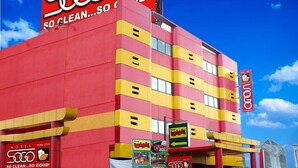 A multi-story hotel with a red and yellow facade, multiple balconies, and a prominent sign reading "SO CLEAN...SO GOOD!". - Hotel Sogo Cabanatuan (Cabanatuan)