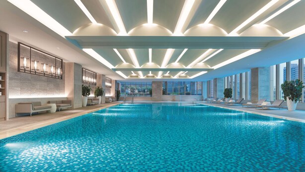 A modern indoor swimming pool with a tiled floor and ceiling lights. - Shangri-La Shenyang (Shenyang)