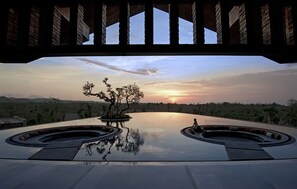 A modern pool area with a sunset view, under a wooden structure. - RIMBA by AYANA Bali (Jimbaran)