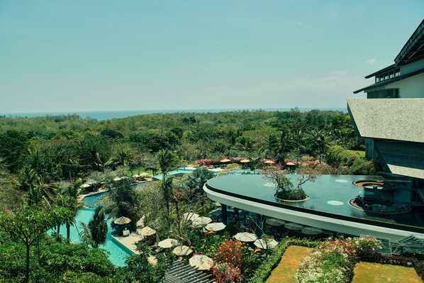 A resort with a large pool, lush greenery, and a modern building. - RIMBA by AYANA Bali (Jimbaran)