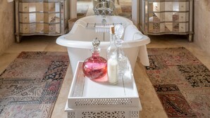 A spacious bathroom with a large bathtub, two sinks, and a red pendant light. - Birkenhead House (Hermanus)
