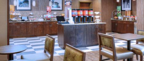 A restaurant with a checkered floor, wooden cabinets, and a coffee bar with multiple dispensers.