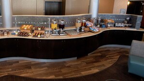 A curved reception desk with a sink, a coffee station, and a breakfast bar. - Doubletree by Hilton Bemidji (Bemidji)