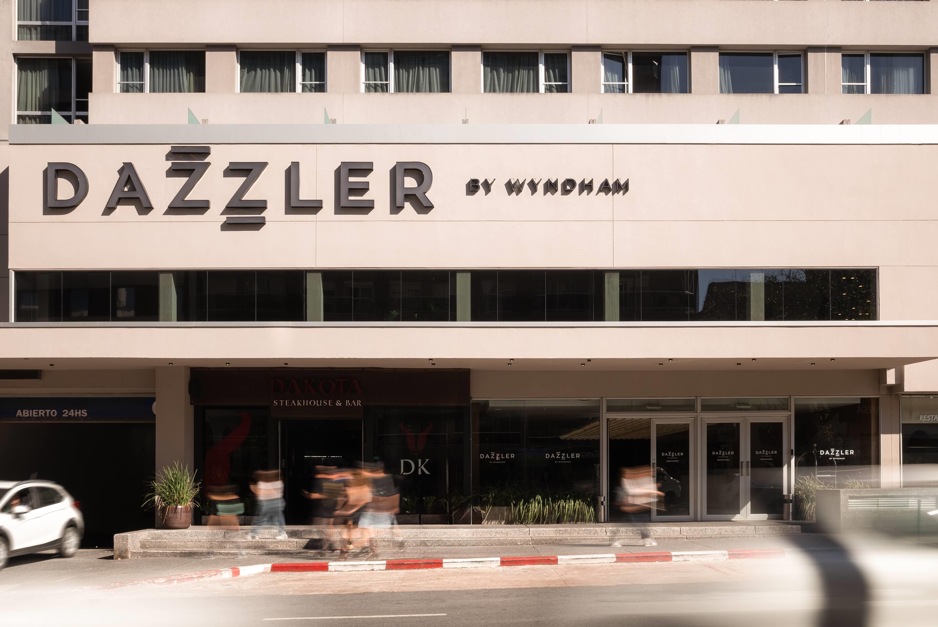 A building with the sign 'DAZZLER BY WYNDHAM' and a 'DAZZLER Steakhouse & Bar' entrance.
