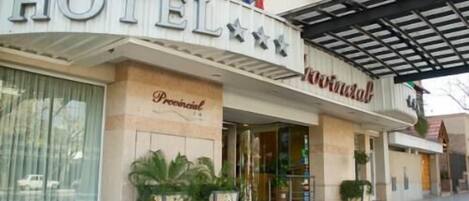 Entrada de hotel con un cartel que dice "HOTEL" y "Pensional".