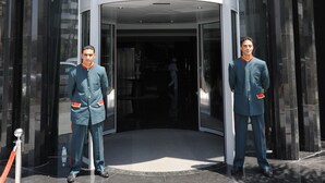 The entrance of the Rive Hotel with a glass door and a revolving door.