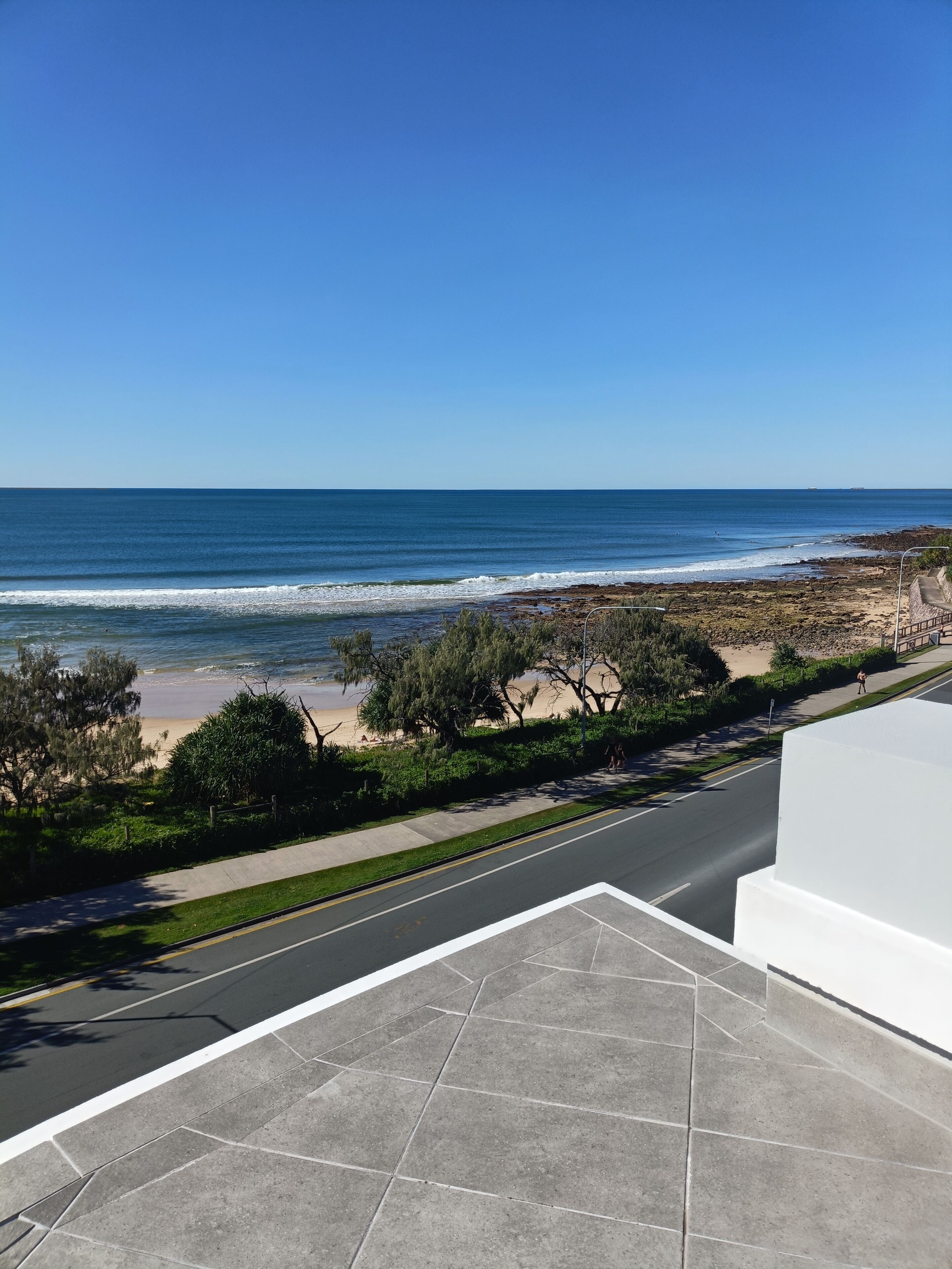 A coastal road with a beach and ocean view.