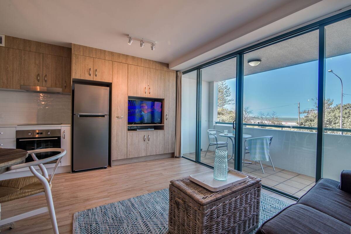 deluxe one bedroom apartment | living area | 40-inch tv with digital channels, dvd player