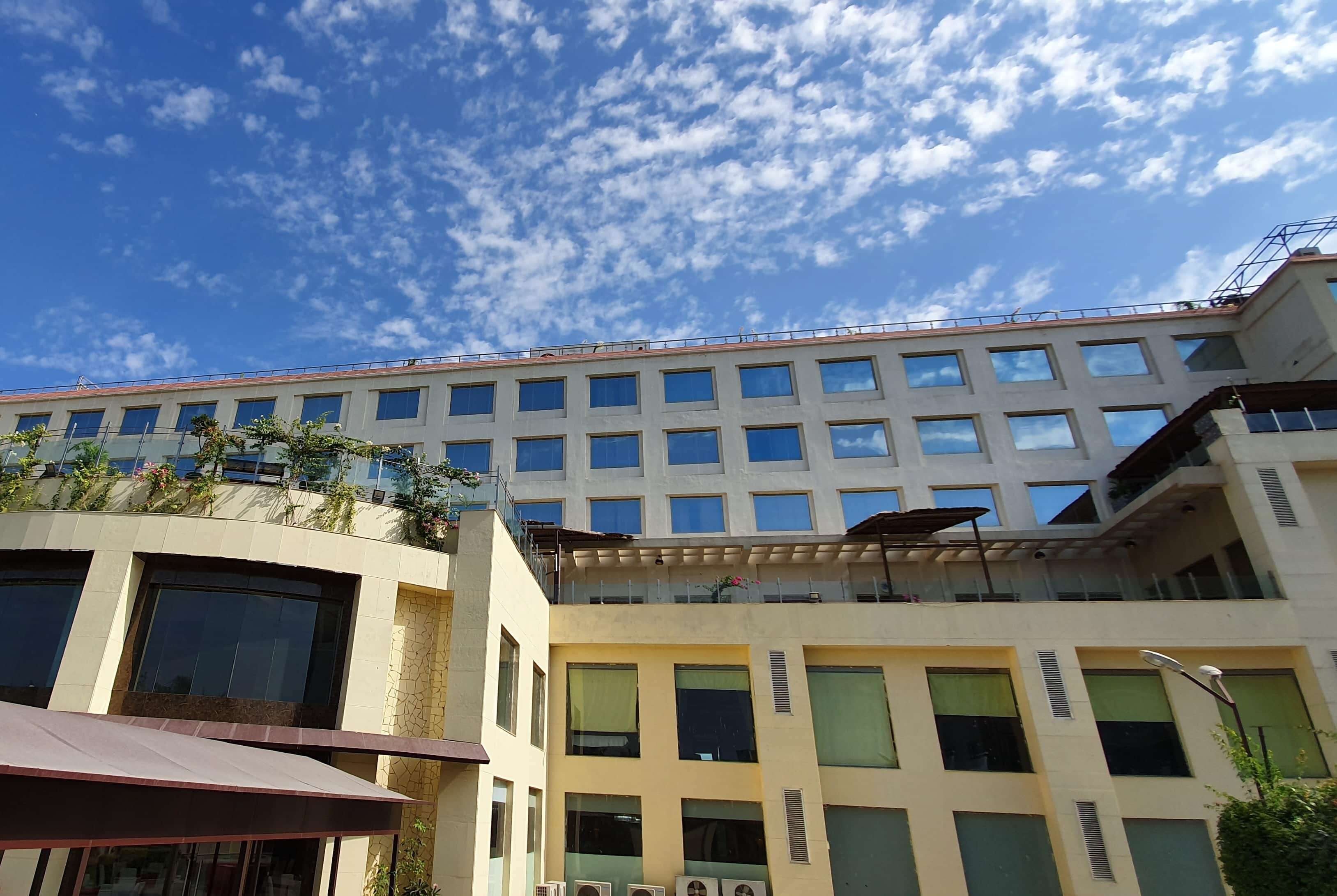 A multi-story building with a flat roof and numerous windows.