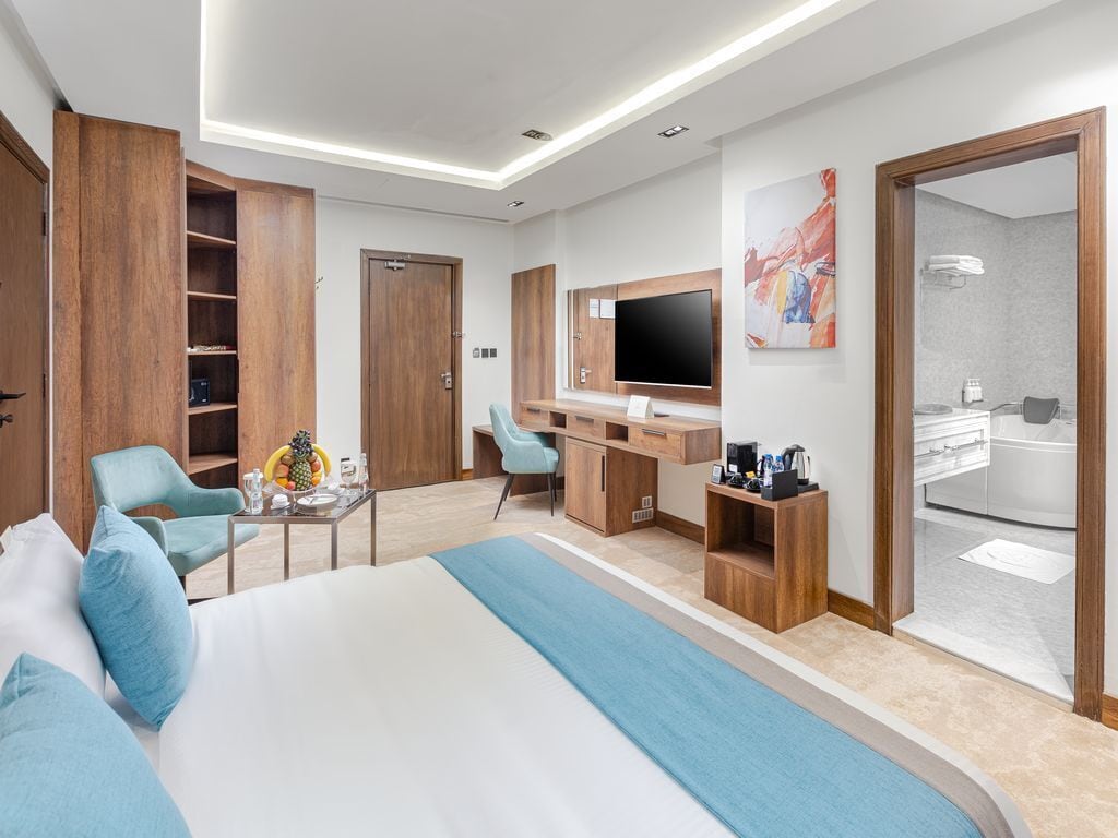 Junior Suite | Minibar, in-room safe, laptop workspace, iron/ironing board