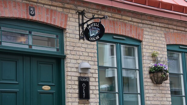 A brick building with a green door and a sign reading "Hotel Oskar." - Hotell Oskar (Lund)