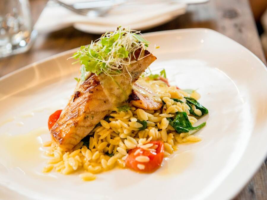 Un plato de comida con arroz, tomates y verduras.