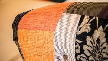A close-up of a fabric with a striped pattern and a decorative patch.