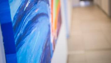 A hallway with a painting on the wall.