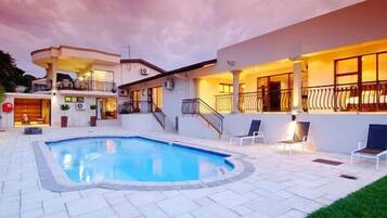 Relax by the pool surrounded by a spacious deck with lounge chairs.