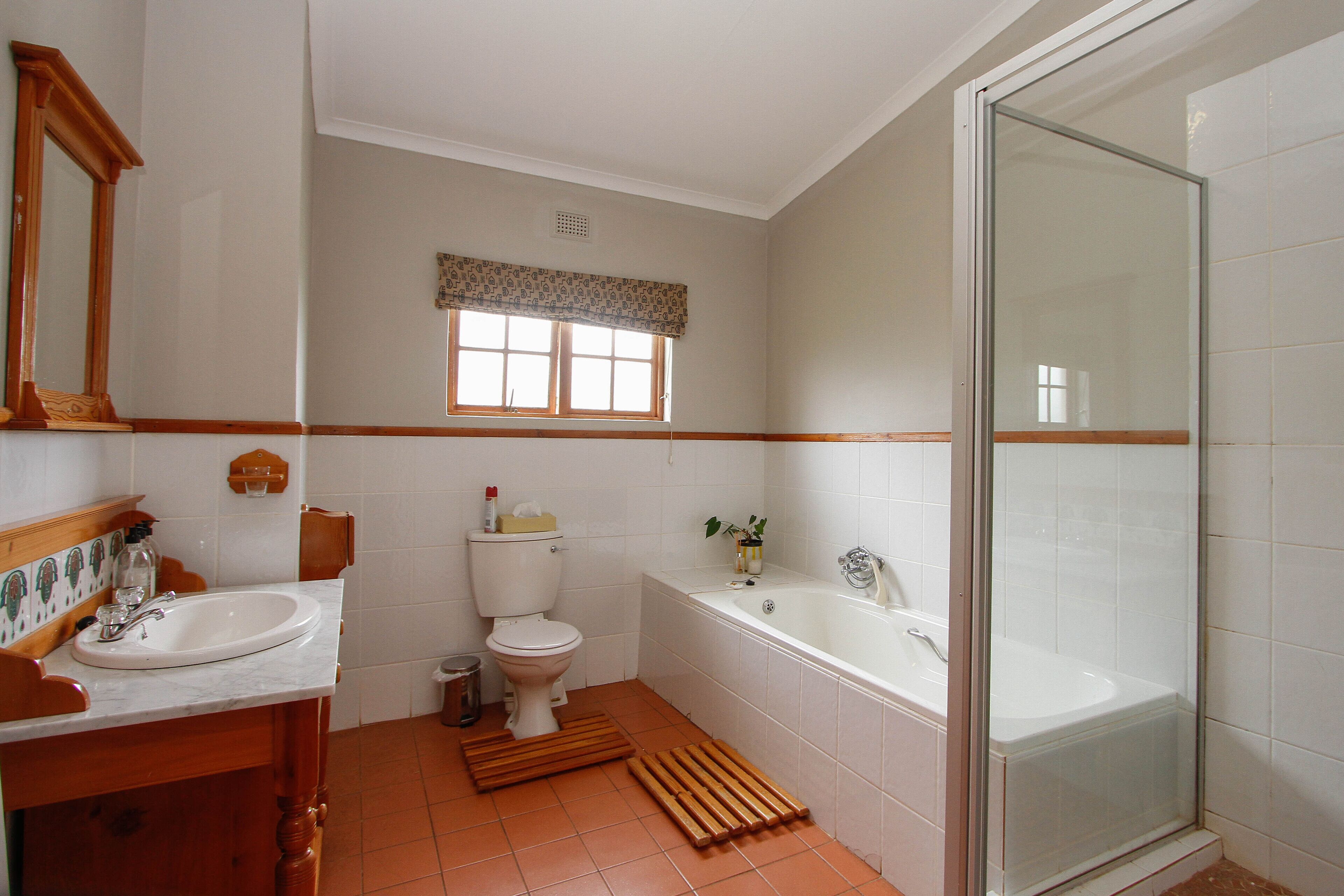 A bathroom with a sink, toilet, bathtub, and a shower.