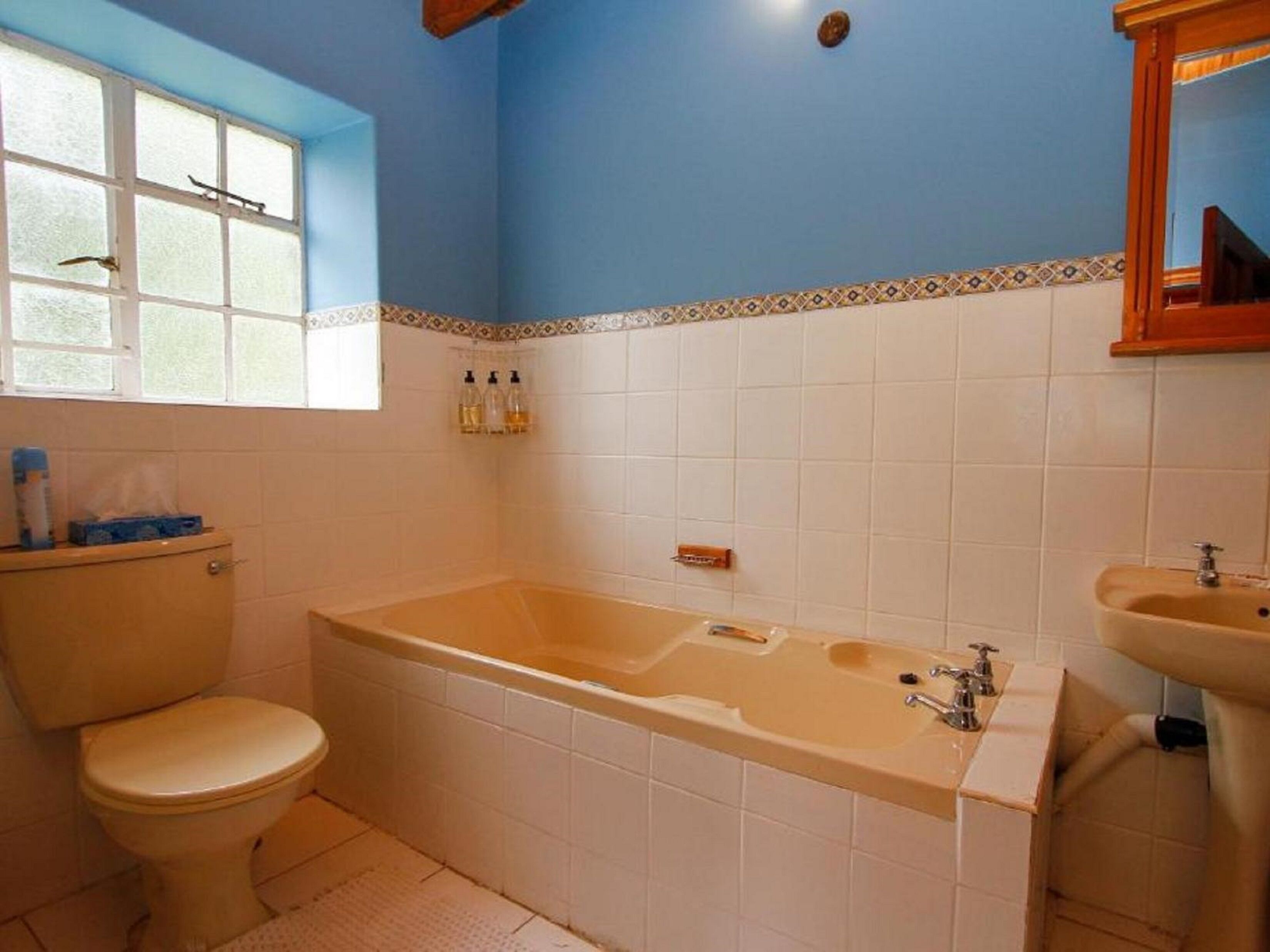 A bathroom with a bathtub, toilet, and sink.