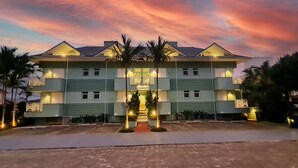 A multi-story hotel with a symmetrical facade, multiple balconies, and a central entrance with steps.