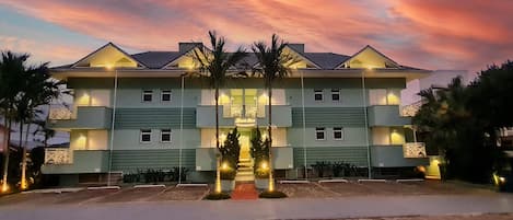 A multi-story hotel with a symmetrical facade, multiple balconies, and a central entrance with steps.