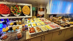 A buffet with various food items and beverages.