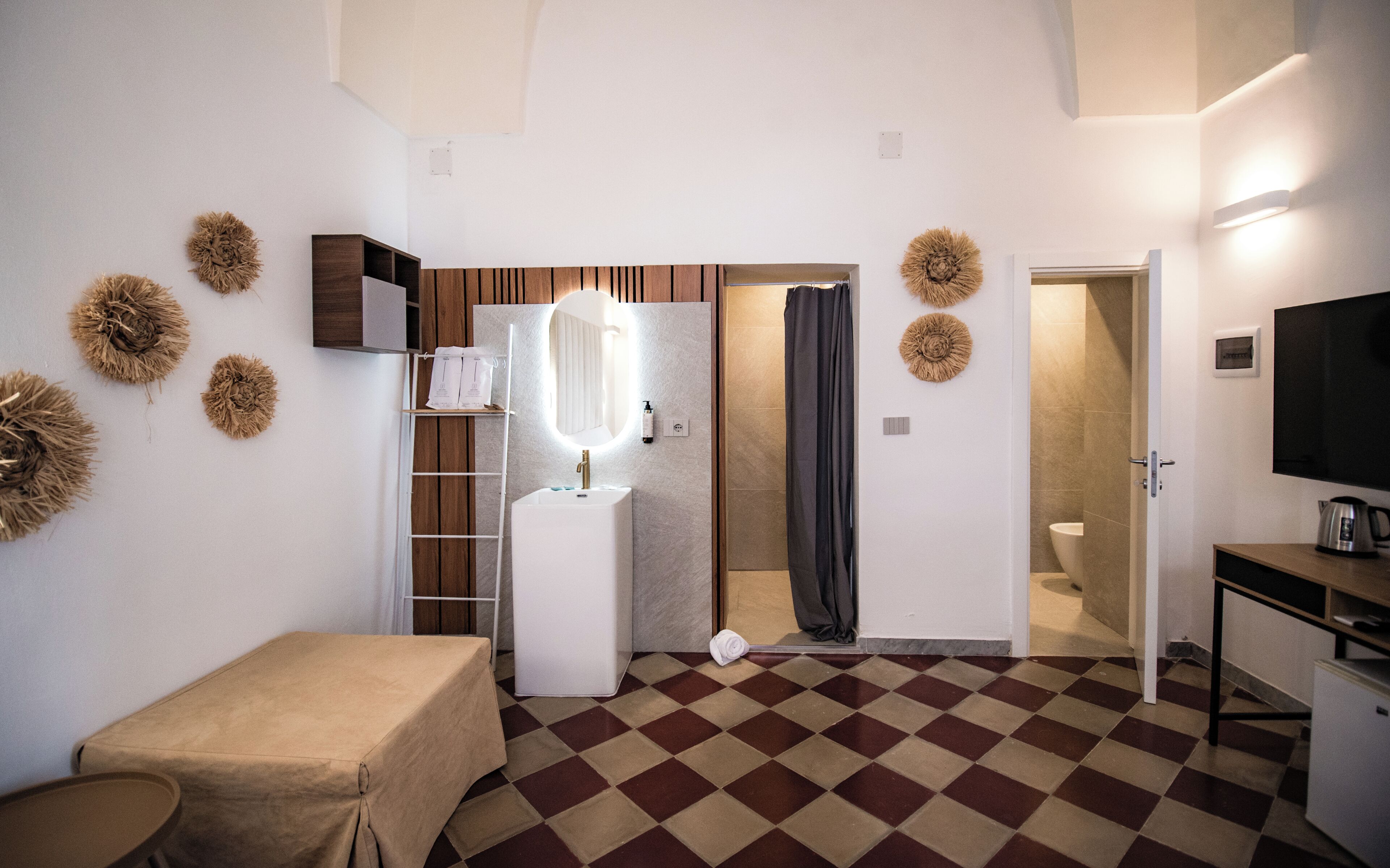 A compact bathroom with a shower, toilet, and sink.