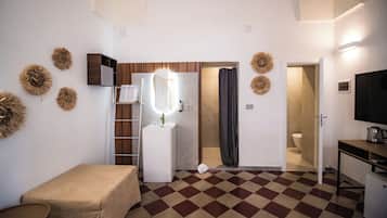 A compact bathroom with a shower, toilet, and sink.