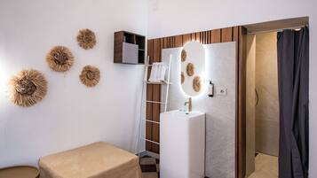 A bathroom with a checkered floor, a sink, a mirror, and a towel rack.