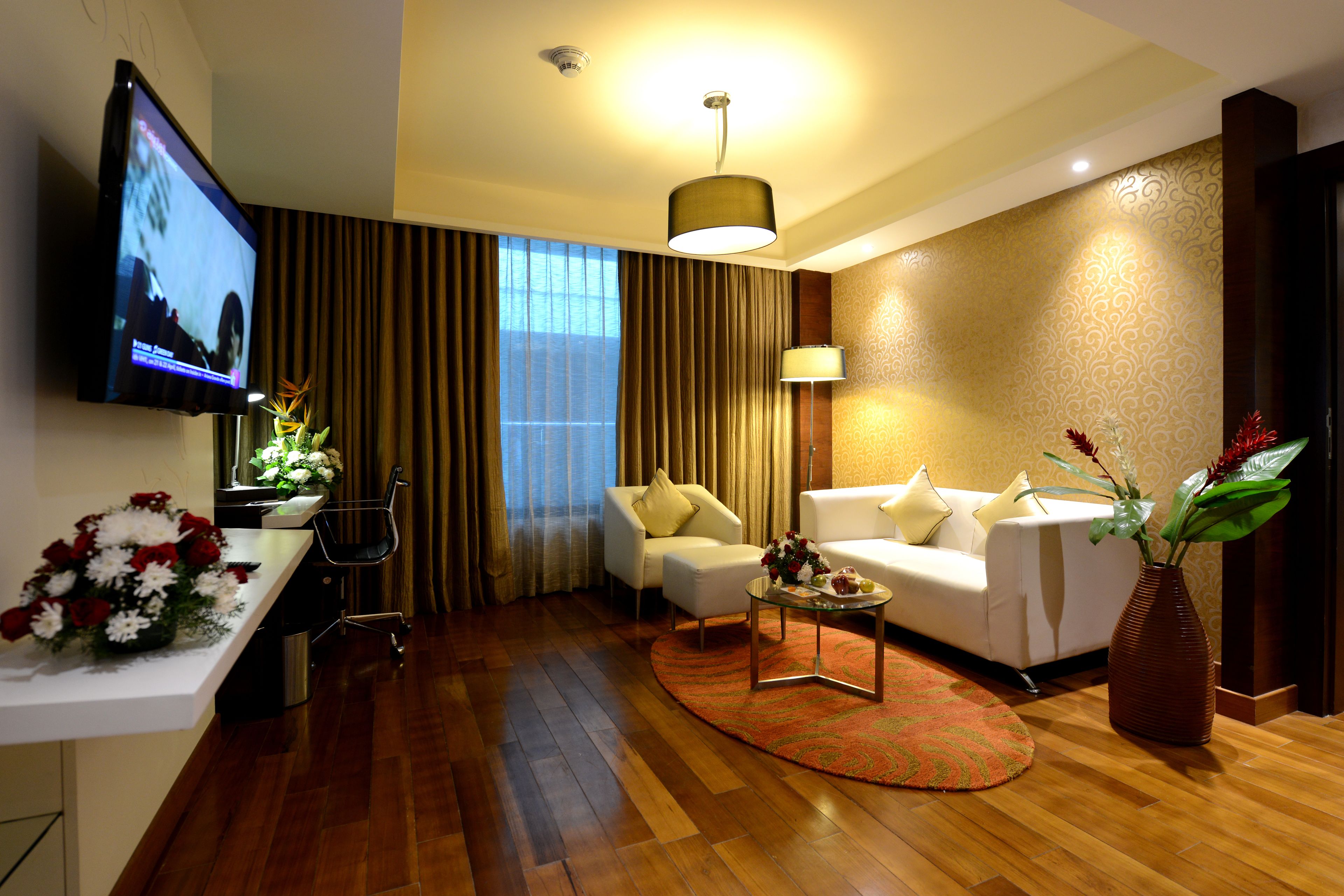 suite room with 2 way airport transfers | living area | lcd tv, fireplace, books