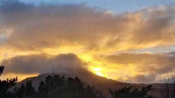 A mountain landscape with a sunset.