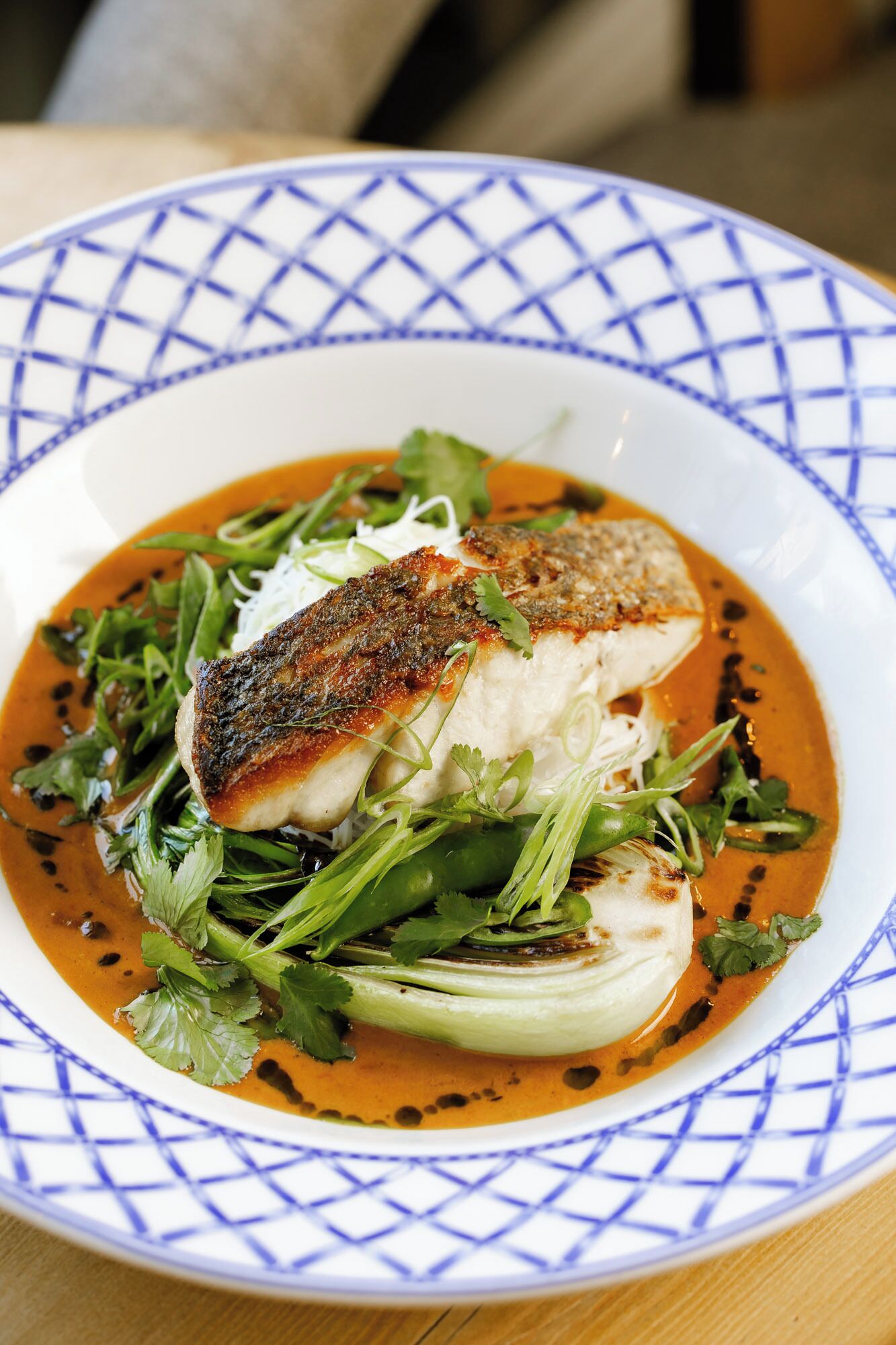 A plate of food with a blue patterned rim.