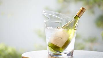 A clear glass with a bottle of white wine resting in it.