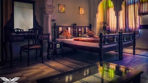 A room with a bed, a desk, a chair, and a small table. - Krishna Palace - A Heritage Boutique Hotel (Jaipur)