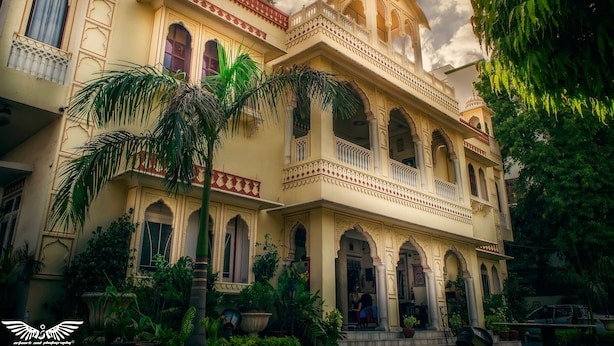 A traditional building with multiple balconies, arched windows, and a central dome. - Krishna Palace - A Heritage Boutique Hotel (Jaipur)