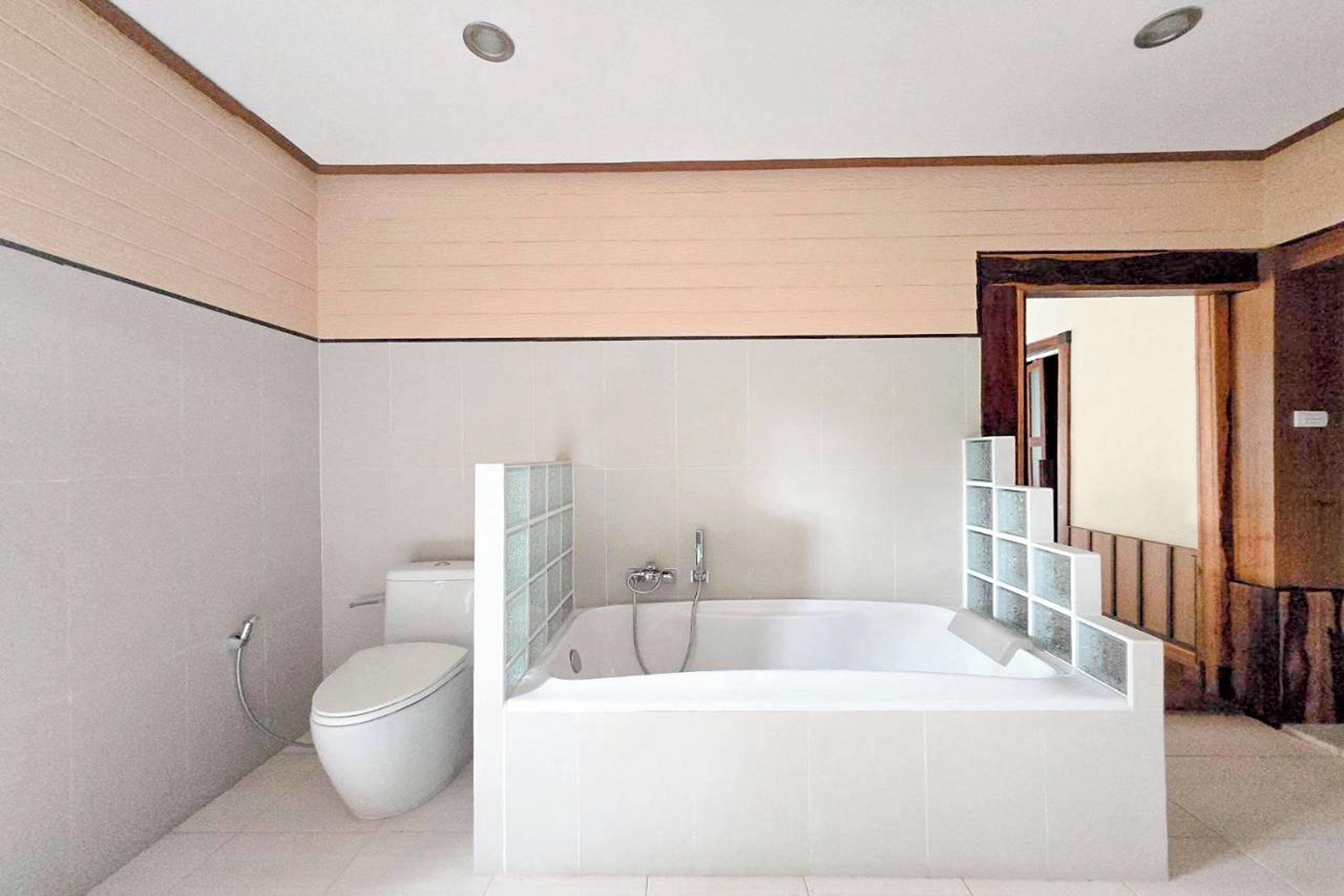 Un baño moderno con una bañera independiente, un inodoro y una zona de ducha.