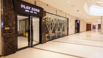 A Play Zone store with a modern interior and a glass facade.