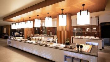 A modern breakfast bar with a variety of food items, wooden accents, and pendant lighting.