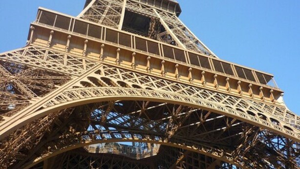 The Eiffel Tower's intricate iron lattice structure. - Hôtel Tourisme Avenue (Paris)