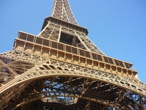 The Eiffel Tower's intricate iron lattice structure. - Hôtel Tourisme Avenue (Paris)