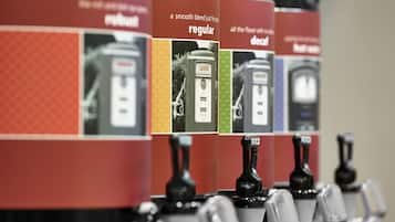 A row of coffee dispensers with labels indicating different types of coffee.