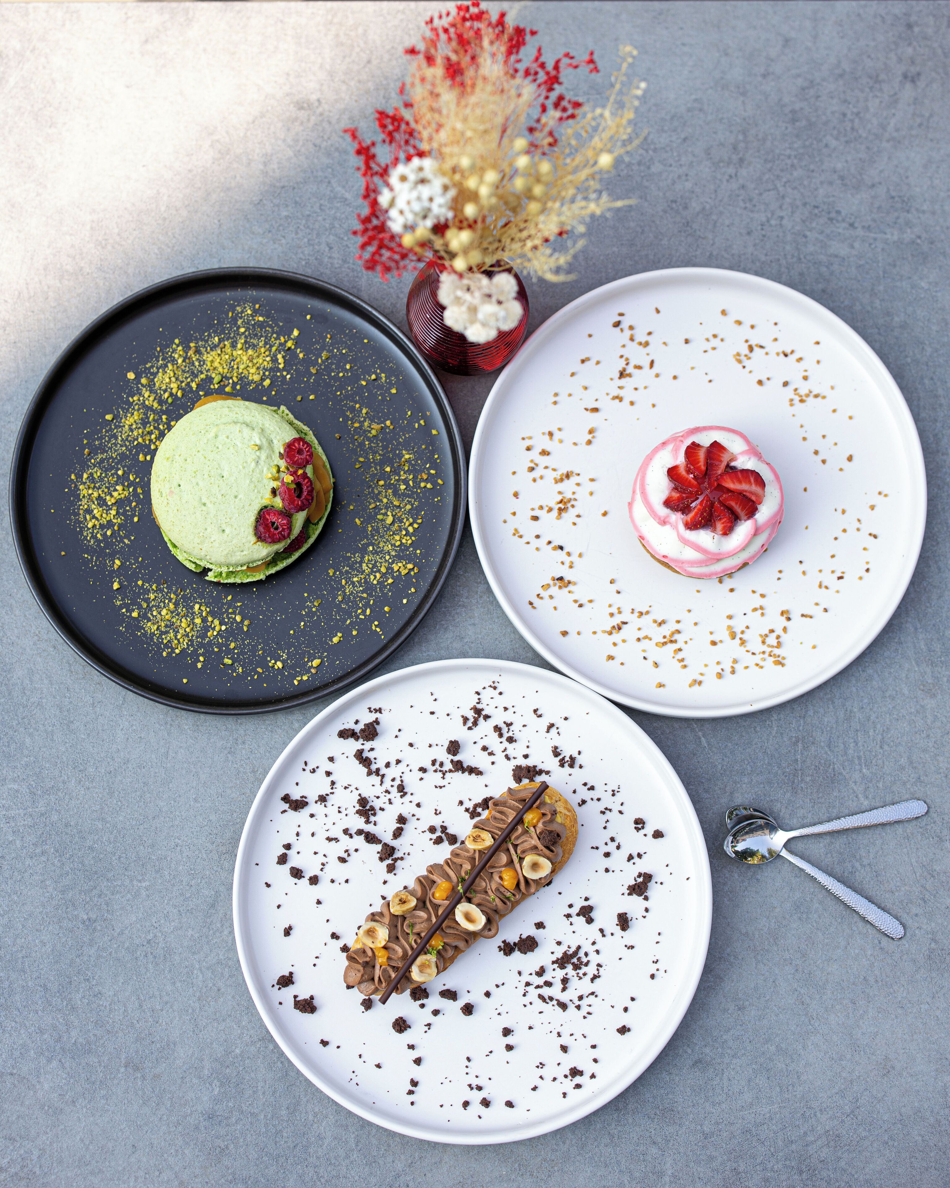 Three plates of desserts on a table.
