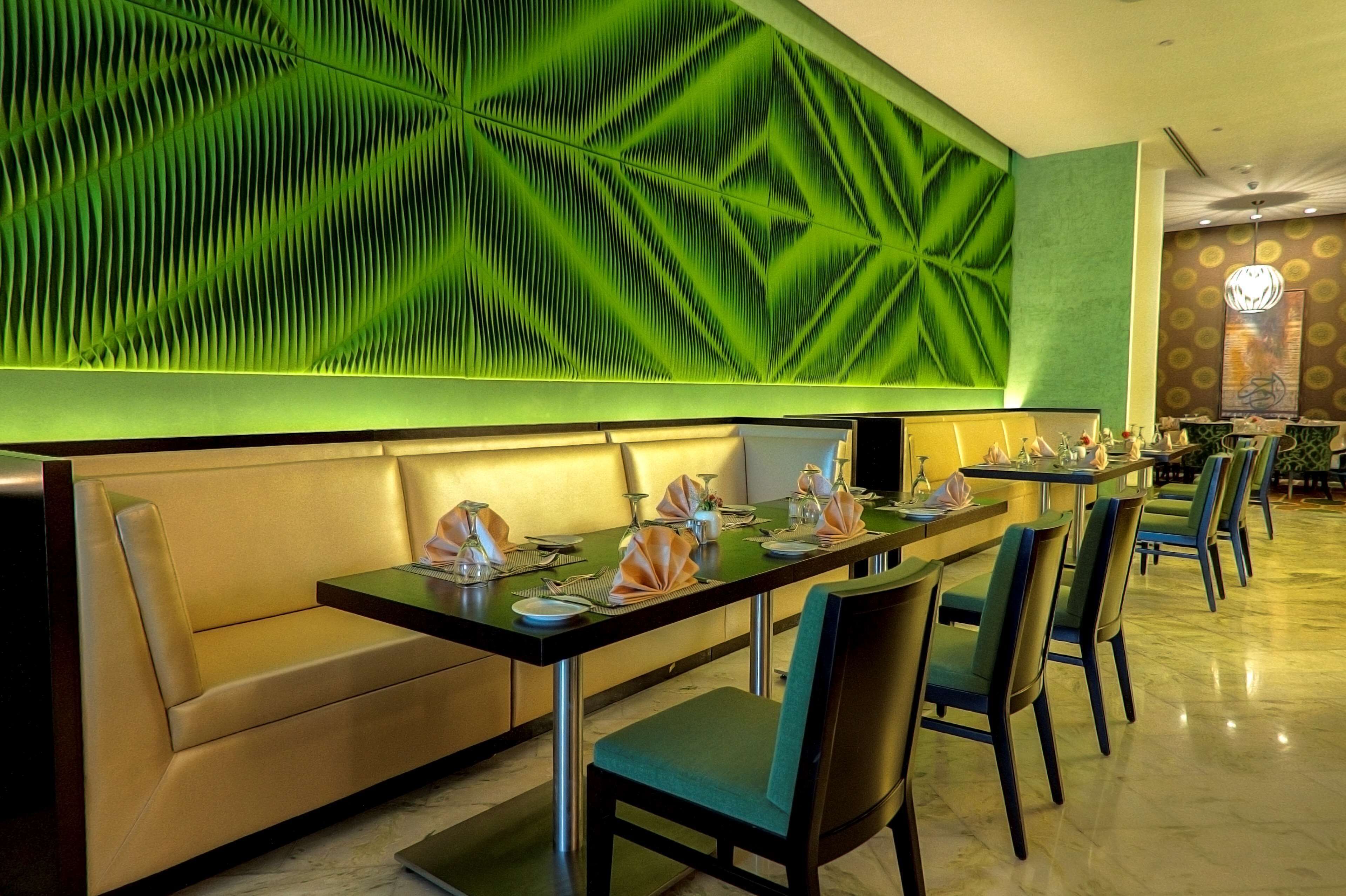 Ein Restaurant mit einem langen Esstisch, einer Couch und Stühlen.